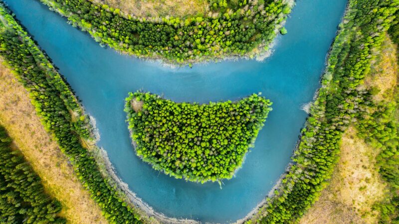 View of the river and the island like a smile from a bird's eye view. Forest zone with a river in Belarus View of the river and the island like a smile from a bird's eye view. Forest zone with a river in Belarus.